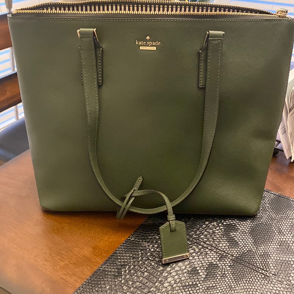 Kate spade tote , rare dark green . Excellent condition with matching wallet.